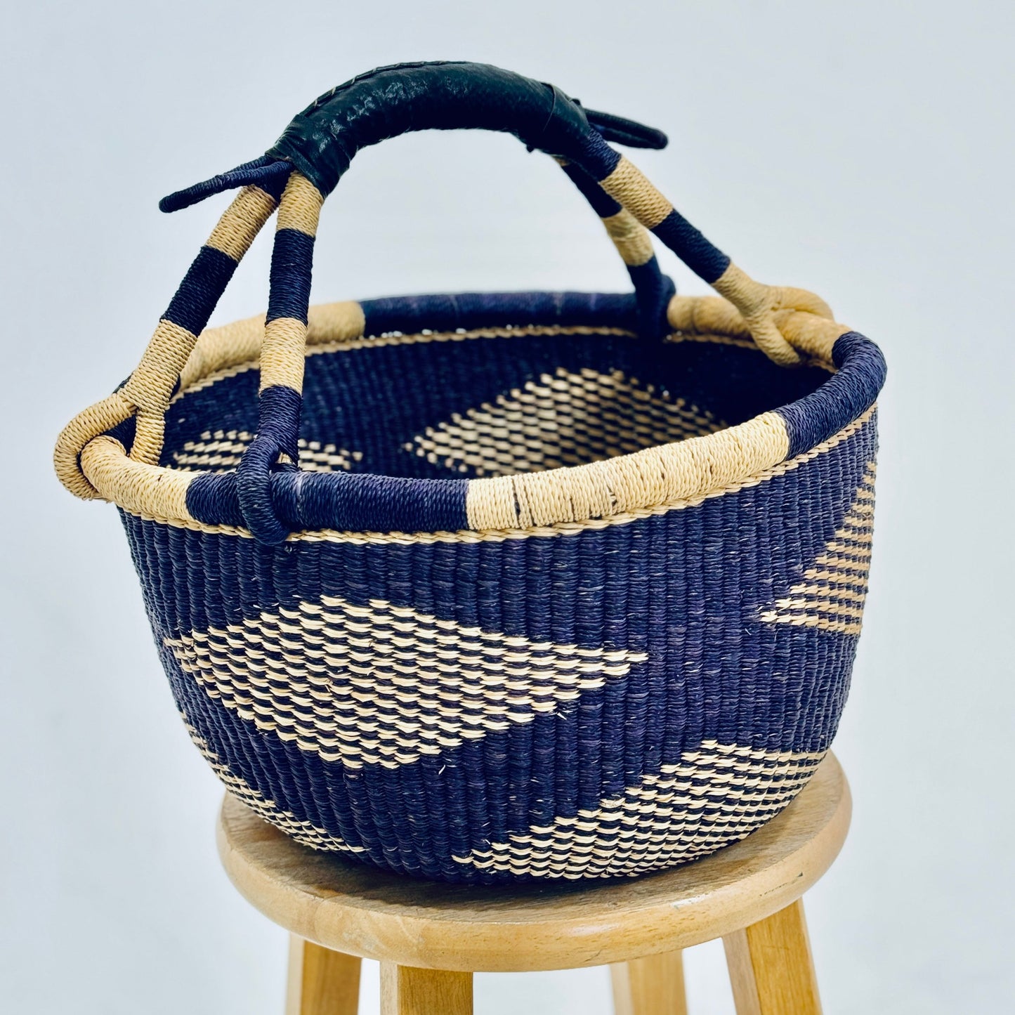 Handmade bread holder basket with black pattern, ideal for bread, fruit, and dry side dishes. Adds rustic charm to any table setting.